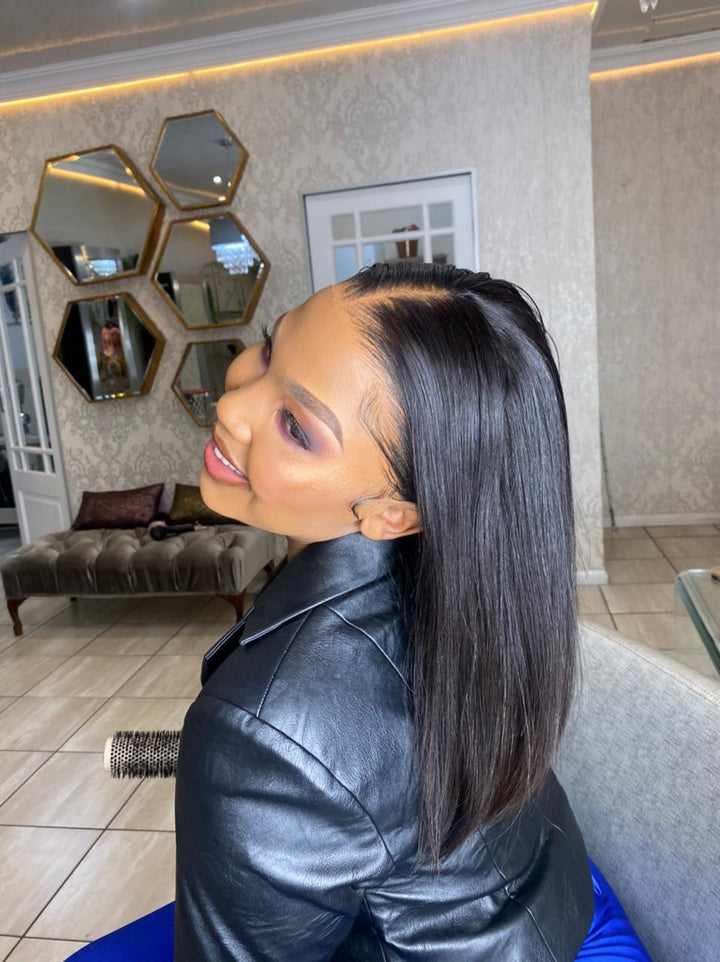 Woman with styled hair in a salon setting wearing a 12-inch straight double drawn 13x4 HD ear-ear