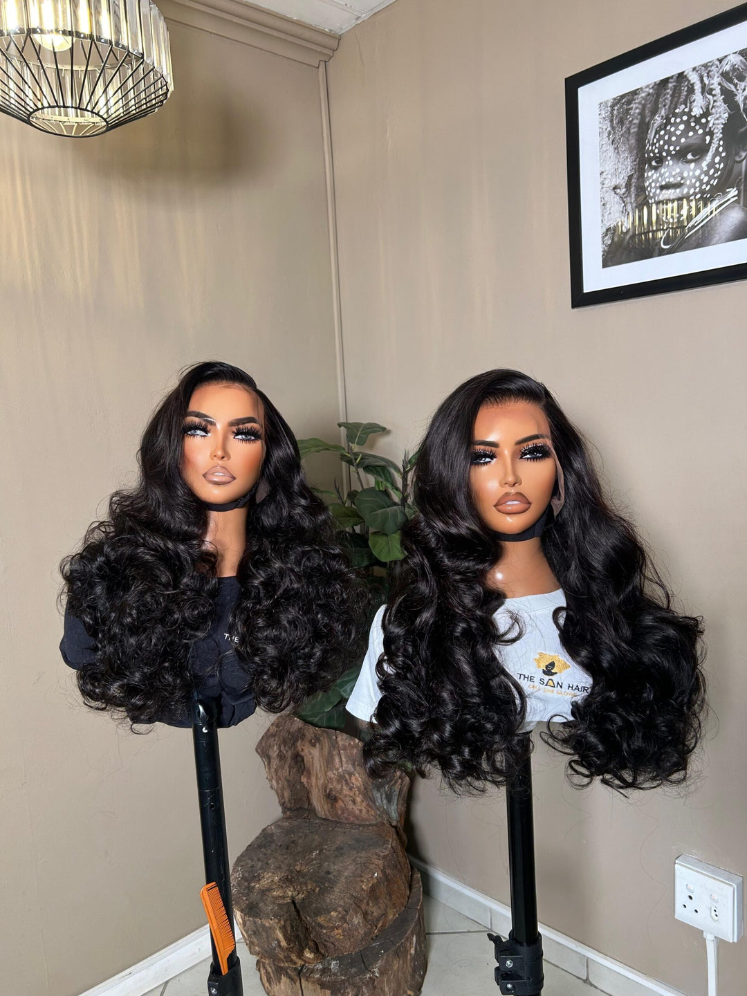 mannequin wearing 28-inch bone-straight black human hair wig with a 13x4 lace frontal, styled long and thick from root to tip