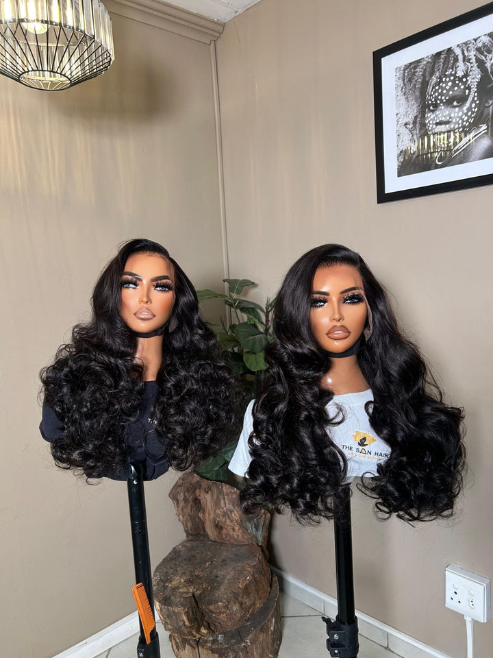 mannequin wearing 28-inch bone-straight black human hair wig with a 13x4 lace frontal, styled long and thick from root to tip