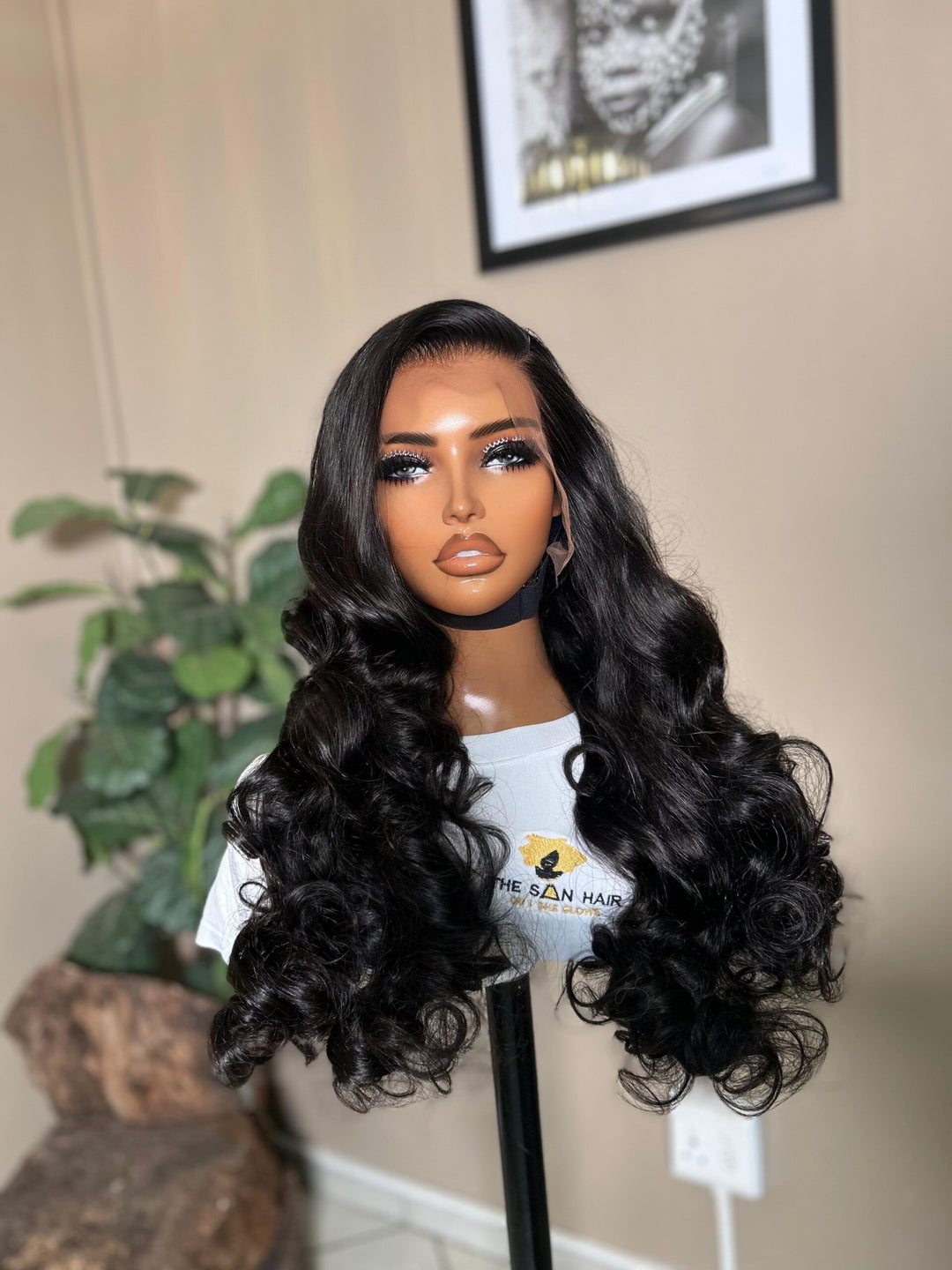 mannequin wearing 28-inch bone-straight black human hair wig with a 13x4 lace frontal, styled long and thick from root to tip
