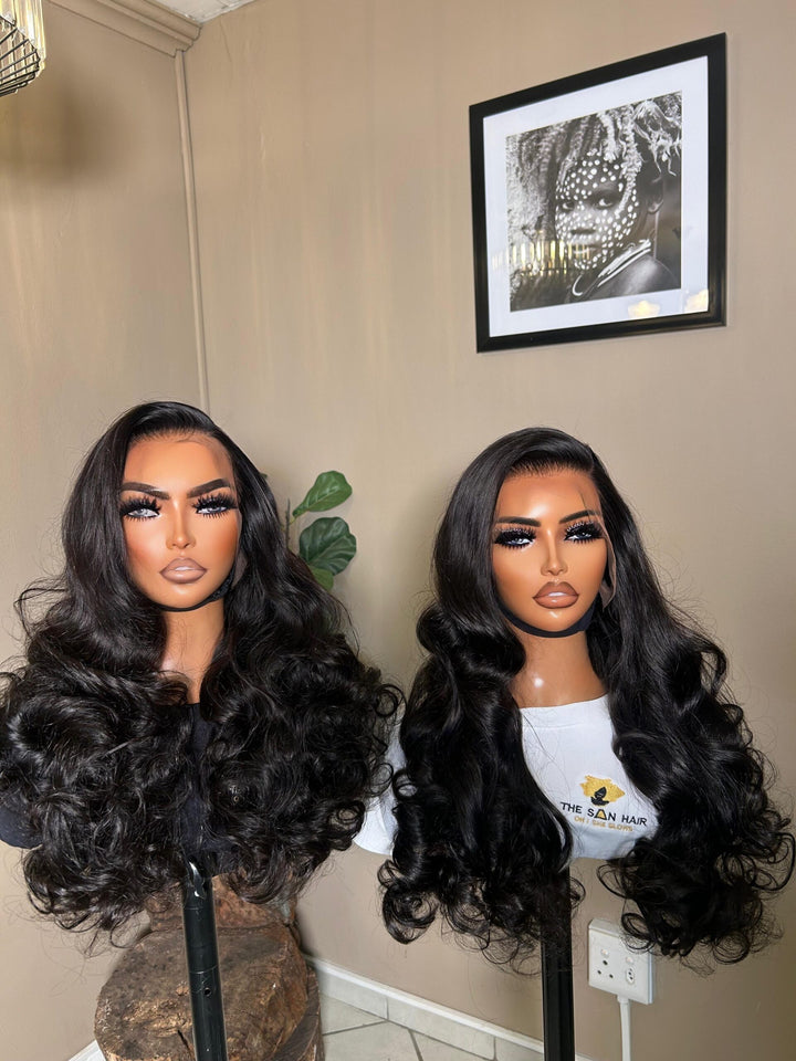 mannequin wearing 28-inch bone-straight black human hair wig with a 13x4 lace frontal, styled long and thick from root to tip