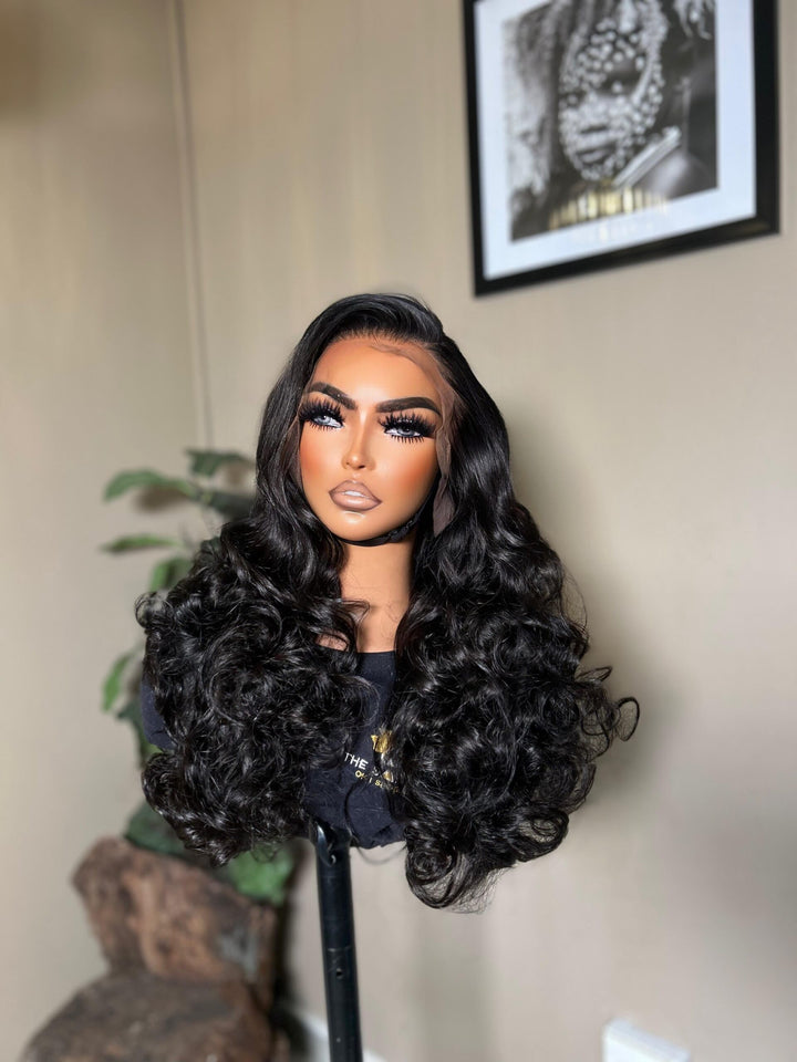 mannequin wearing a 28-inch bone-straight black human hair wig with a 13x4 lace frontal, styled long and thick from root to tip